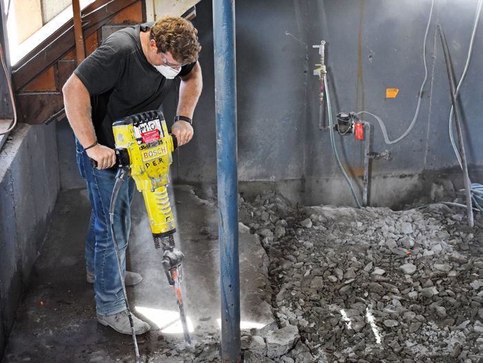 Kevin O'Connor breaks up concrete to be removed.